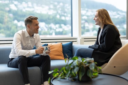 two people talking on a sofa