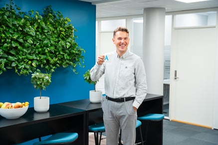 man smiling with cup in hand