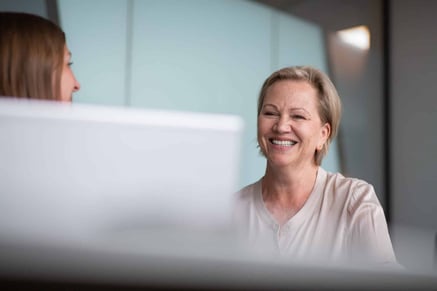 lady smiling in front of pc