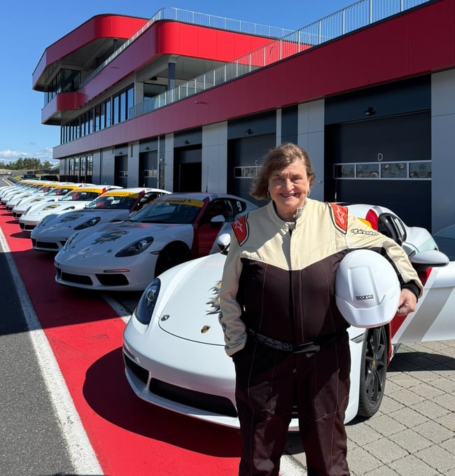Lady smiling in front of sports car